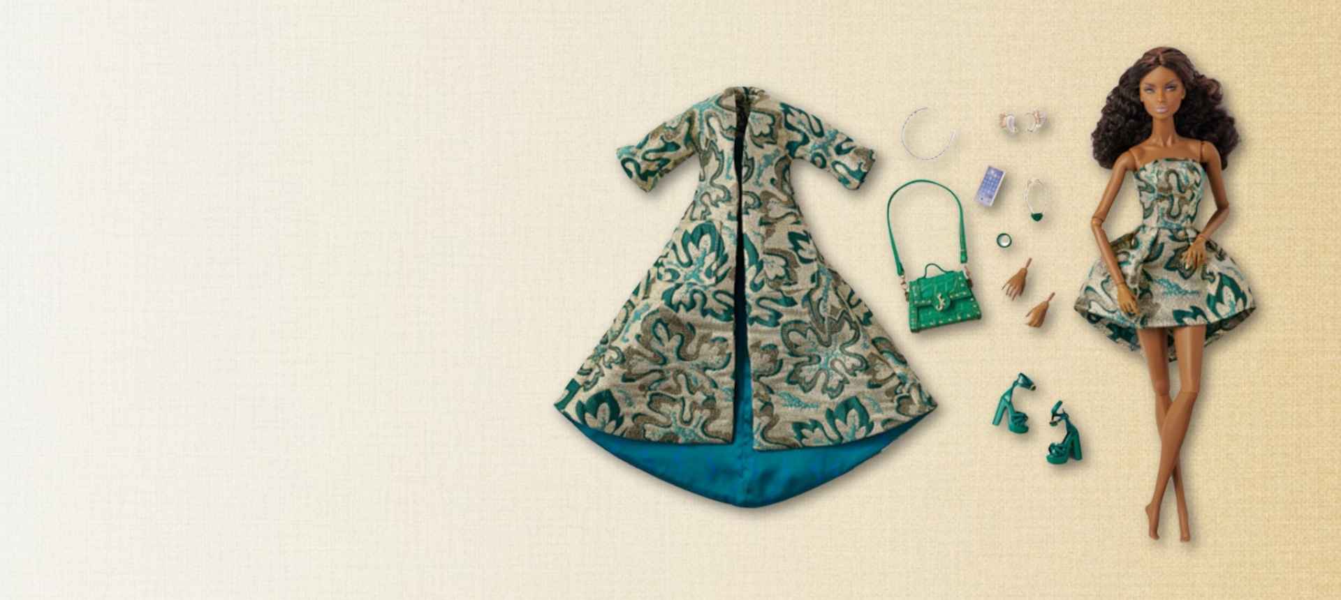 Integrity Toys doll with patterned dress and accessories on a beige background