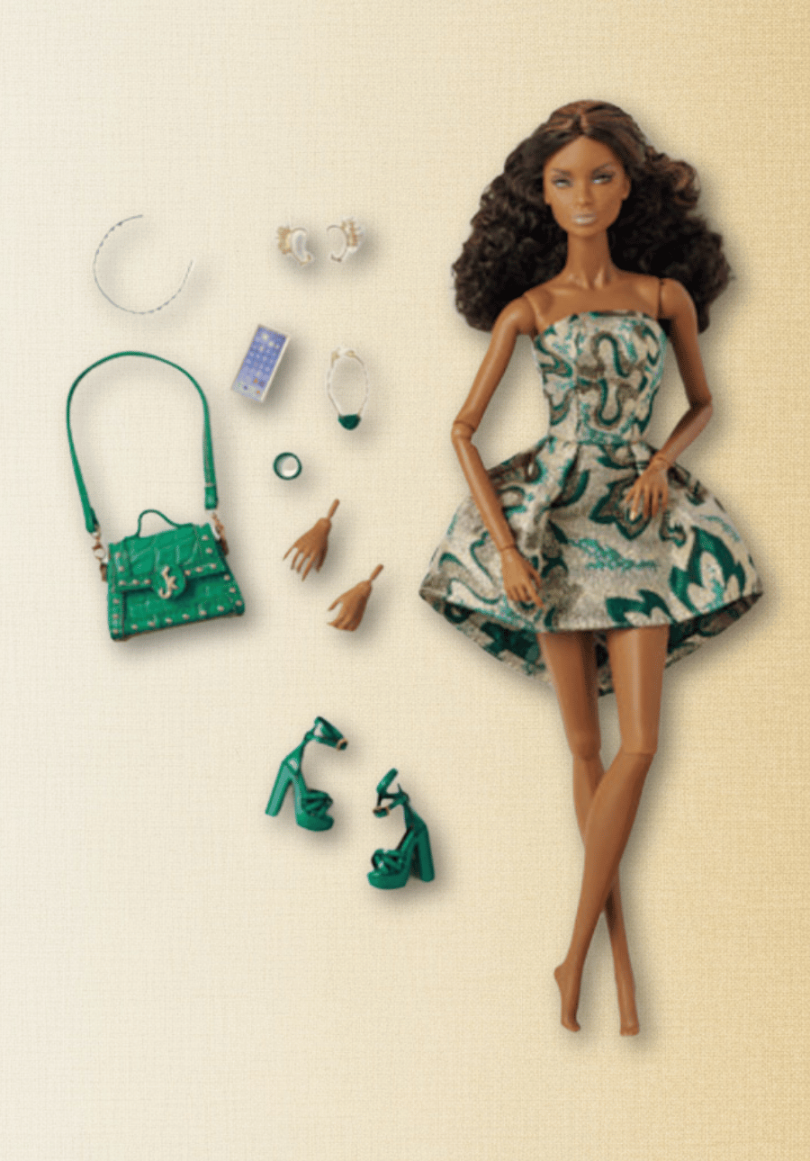 Integrity Toys doll with green dress and accessories on a beige background