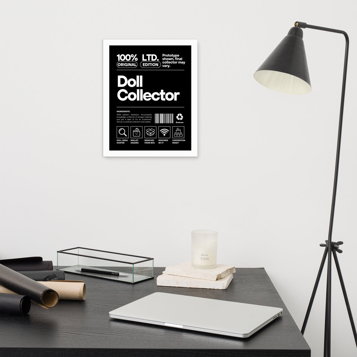 Modern desk setup with a lamp, laptop, and decorative items against a white wall. 'Doll Collector' Product Label Design Framed Print - 11″ × 14″ (27.9 cm × 35.6 cm) Wall Art for Adult Collectors