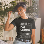 Person wearing a black t-shirt with 'Doll Collector' text in a casual setting