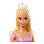Barbie doll with blonde hair, blue eyes, a pink dress, and white tiara on a white background